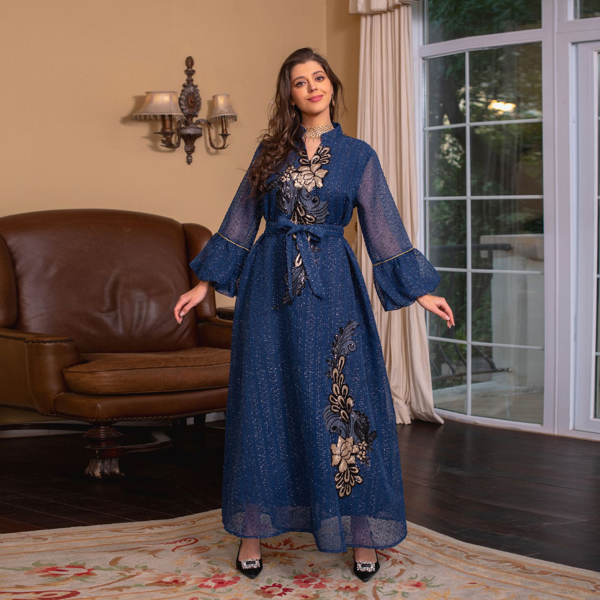 Jalabiya Elevate your style with a fashionable and avant-garde jalabiya | featuring embroidered appliques | bell sleeves | a waist-cinching tie | and a contemporary edge