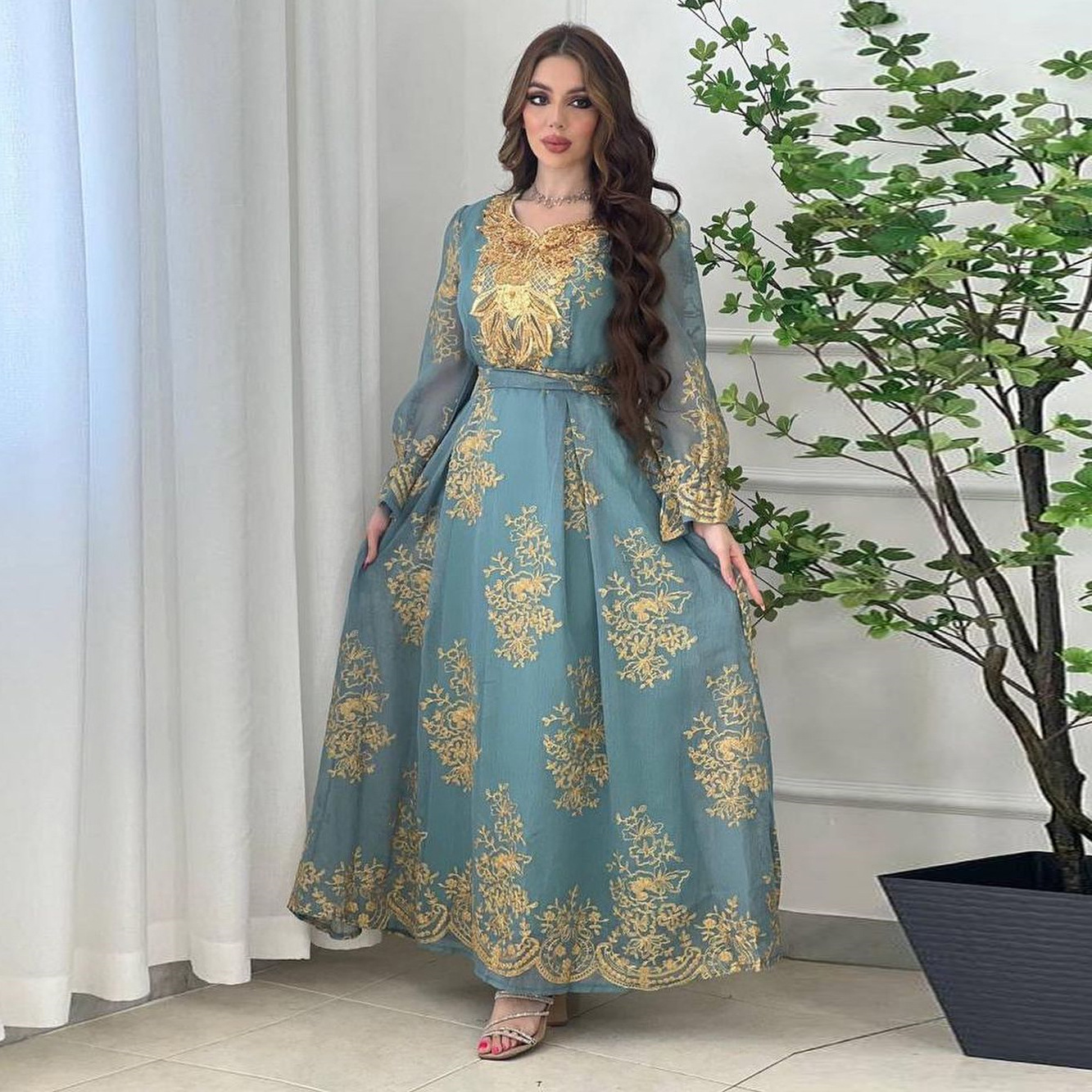 Jalabiya Embrace elegance with an embroidered jalabiya adorned with appliques | a floor-length evening robe | a waist-cinching belt | and an aura of grace
